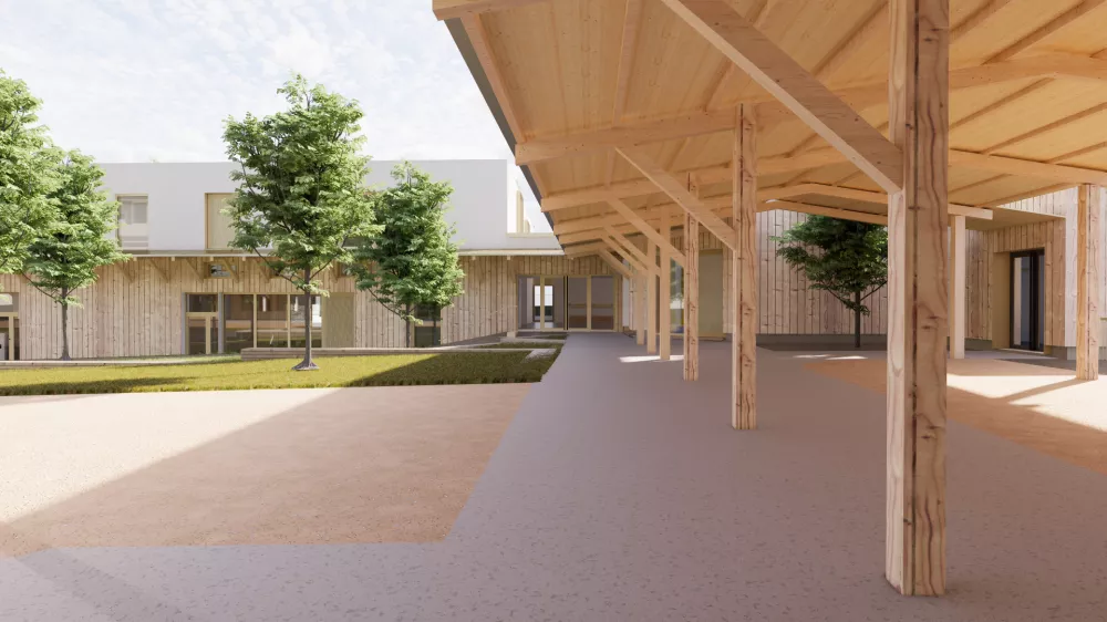 Crédit photo NUNC Architecture : Vue sur le préau avec charpente apparente